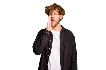 Young caucasian man isolated on green chroma background shouting excited to front.