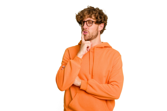 Young caucasian man isolated on green chroma background looking sideways with doubtful and skeptical expression.