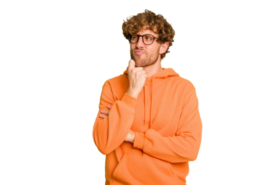Young caucasian man isolated on green chroma background looking sideways with doubtful and skeptical expression.