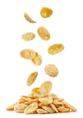 Corn flakes fall on a pile on a white background. Isolated