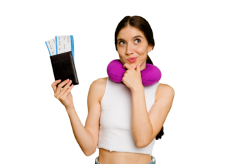 Young caucasian woman with inflatable travel pillow holding a passport isolated looking sideways with doubtful and skeptical expression.