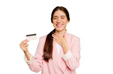 Business caucasian woman holding a credit card isolated laughs out loudly keeping hand on chest.