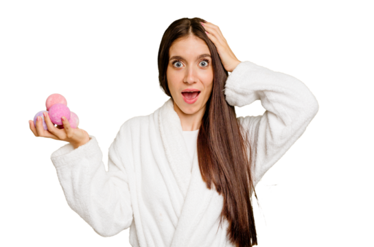 Young caucasian woman holding aromatic balls isolated being shocked, she has remembered important meeting.