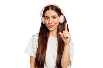 Young caucasian woman wearing headphones isolated showing number one with finger.
