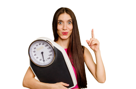 Young caucasian woman holding a scale isolated having some great idea, concept of creativity.