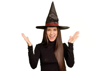 Young caucasian woman dressed as a witch for halloween day isolated receiving a pleasant surprise,...