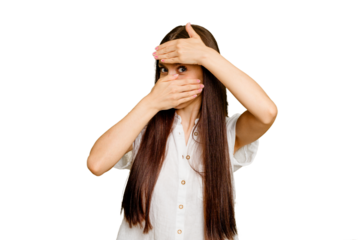 Young caucasian long hair woman isolated blink at the camera through fingers, embarrassed covering face.