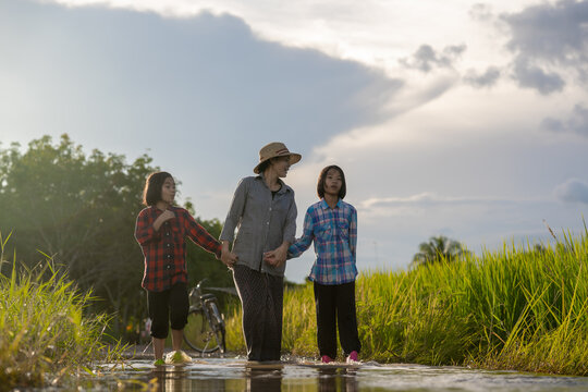 Mother and daughter are asian family walking and looking flooding in rural