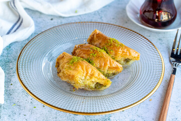 Pistachio sobiyet baklava. Traditional Mediterranean cuisine delicacies. Triangular baklava on a gray background. close up