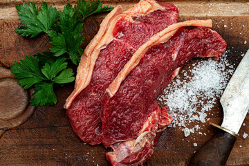 Raw fresh meat picanha steak, traditional Brazilian cut with parsley, coarse salt and knife on...