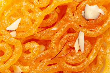 Close-Up of Indian Classical  Sweet Jalebi . Garnished with kesar (Saffron) and dry nuts, Jalebi is one of the most delicious sweets widely used in India. Selective Focus on Subject,