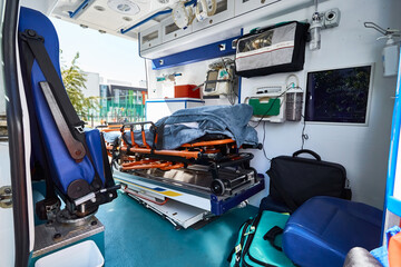 Ambulance interior with gurney, defibrillator and other medical equipment and supplies carried onboard. EMS