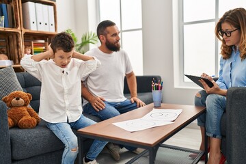 Family having psychology session son with hands on ears at psychology center