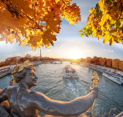 Fototapeta na wymiar Alexandre III bridge in Paris against Eiffel Tower with autumn leaves, France