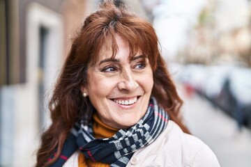 Middle age woman smiling confident standing at street