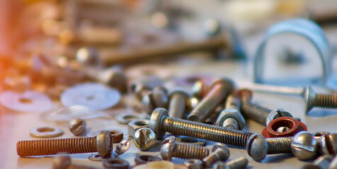 Blurred construction background with nuts and bolts.