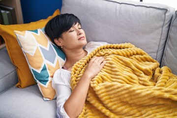 Middle age chinese woman lying on bed sleeping at home