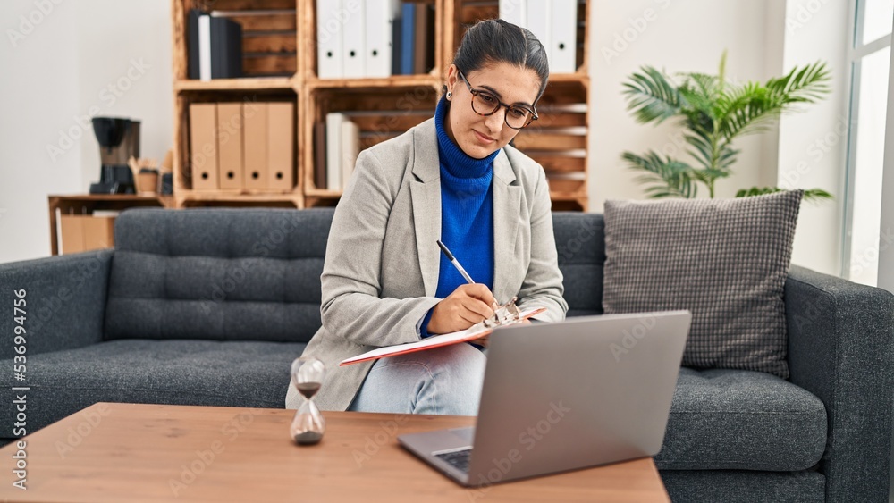 Canvas Prints Young hispanic woman having online psychology session at clinic