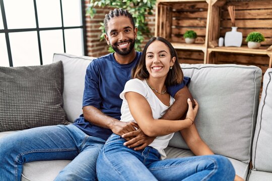 Man and woman couple smiling confident hugging each other at home