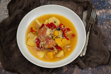 typical portuguese fish stew on white plate on ceramic