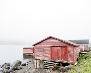Iconic traditional red colored wooden fishing stages that are a part of the fishing culture of Newfoundland and Labrador, Canada.