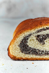 bun with poppy seeds on a white background