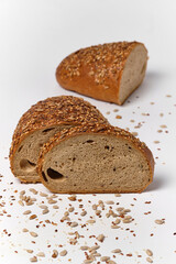 black bread with seeds and sesame on a white background divided into 3 parts