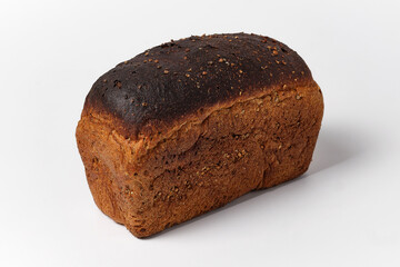 loaf of black bread with seeds on a white background