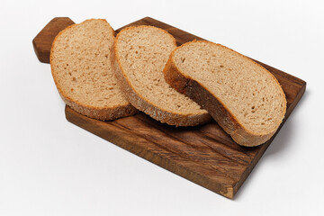 three pieces of black bread on a kitchen board on a white background