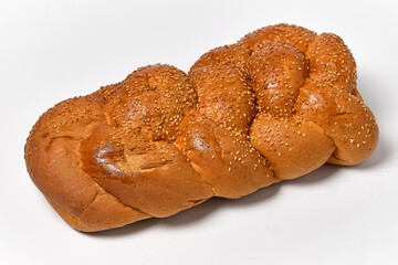braided bread with sesame on a white background close view