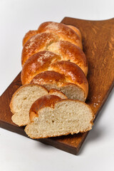 sweet woven buns with sprinkles on a kitchen board on a white background  close view