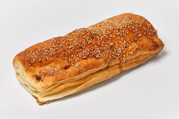puff with sausage and sesame on a white background, close view