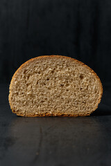 cut standard white bread on a black background, front view