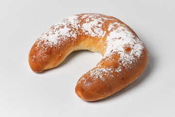 classic sweet bagel with powdered sugar on white background, close view
