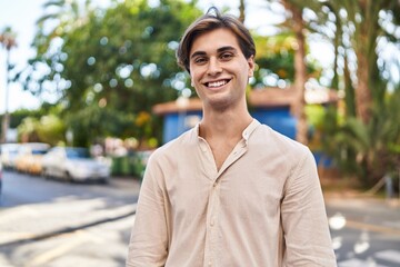 Young caucasian man smiling confident standing at street