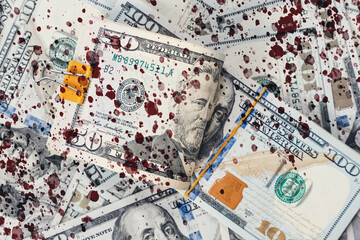 Close up of scattered American dollar bills with blood drops, close-up. Flat lay. The concept of counterfeit money, bribery and illegal corruption