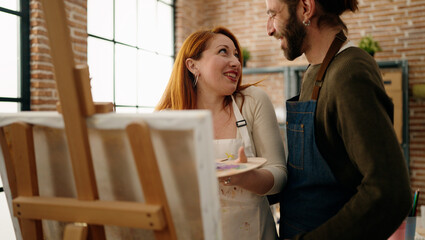 Man and woman couple smiling confident drawing at art studio