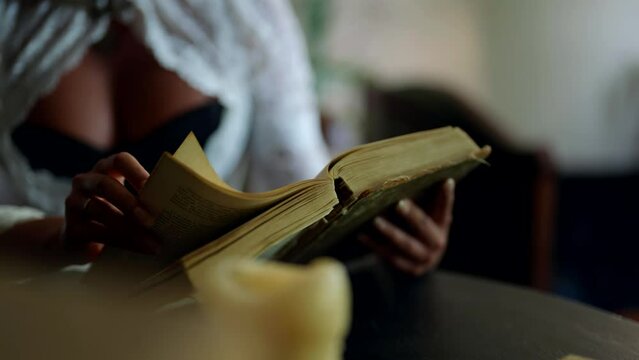 ancient book in hands of beautiful busty woman, closeup view, romantic historical shot in 19 century