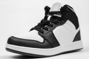 Black and white sneakers on a white background. Stylish new sneakers for advertising a shoe store