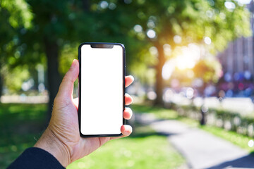Man holding smartphone showing white blank screen at park