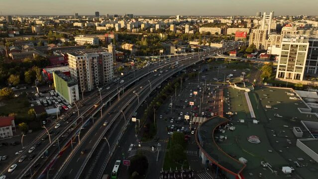 Aerial flight over traffic on highway road in Bucharest during golden sunset 