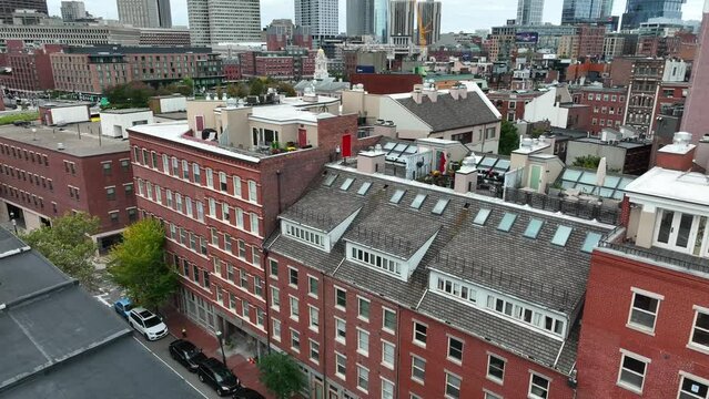 Life in Boston Massachusetts. Aerial establishing shot of apartment homes and downtown skyscraper highrise buildings.