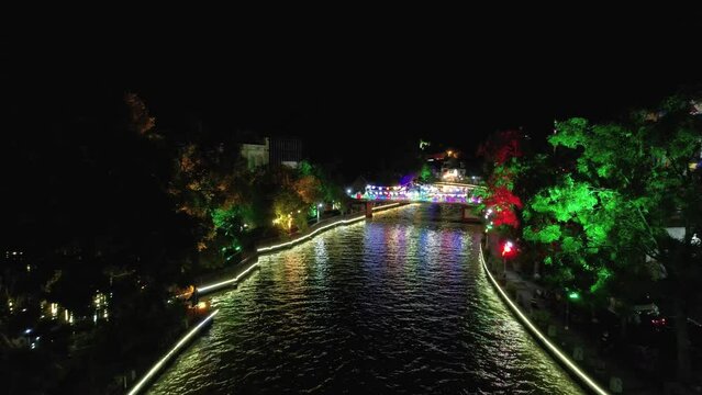 Aerial drone low altitude shot over the Malacca River in Malacca (Melaka), Malaysia at night time.