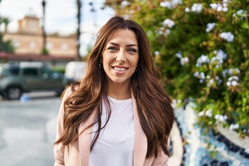 Young hispanic woman smiling confident walking at park