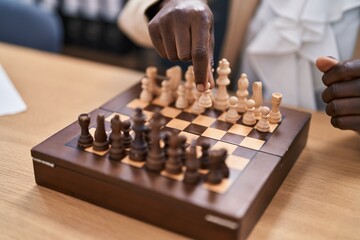 Young african american woman playing chess at home