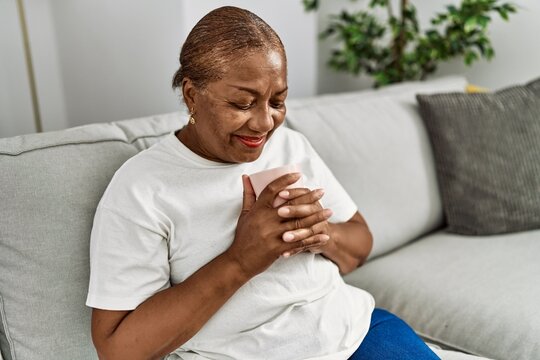 Senior african american woman smiling confident drinking coffee at home
