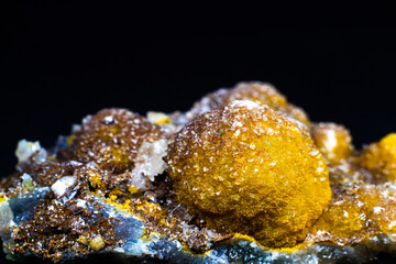 Yellow smithsonite crystal isolated on black surface macro with plenty of detail. Selective focus