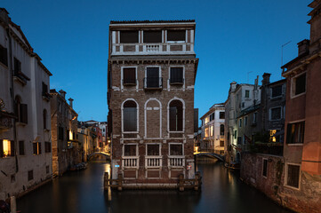 Fototapeta na wymiar View of Tetta Palace in Venice at dusk with blue hour and lights in long exposure photography.