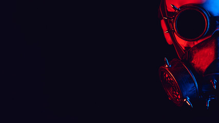 human skull in steampunk glasses and a gas mask with red and blue neon light on a black background