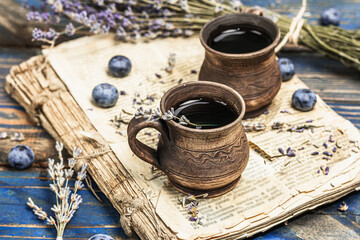 Obraz na płótnie Canvas The concept of rustic style tea. Lavender flowers and blueberries. Vintage book